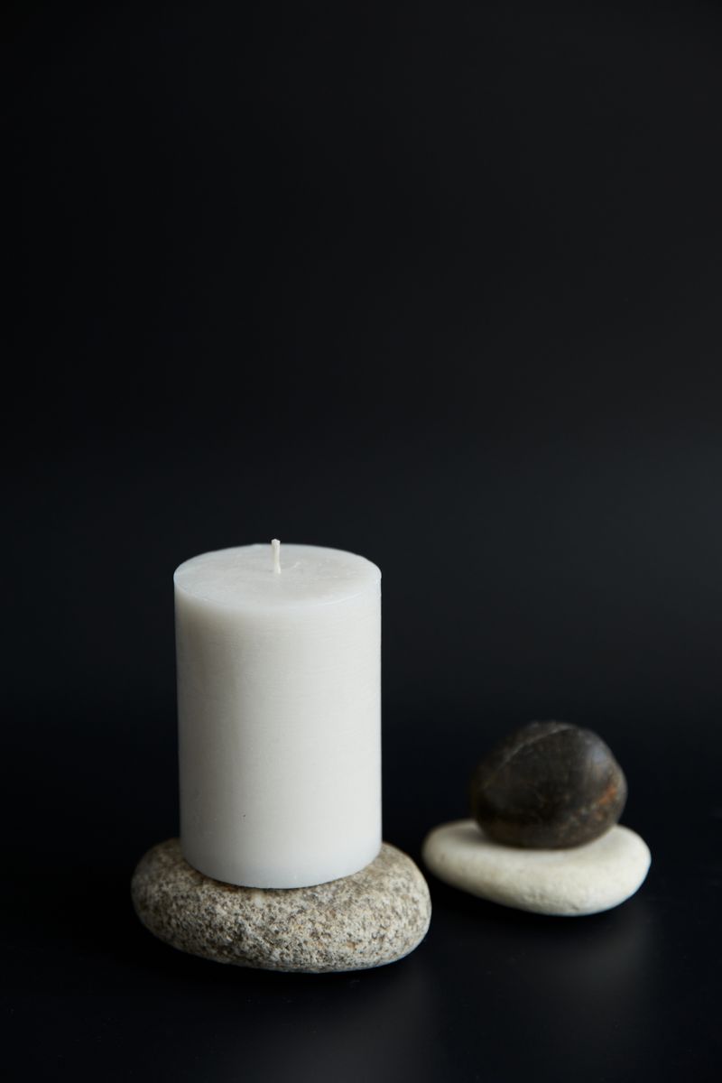 Candles and smooth stones in a serene spa